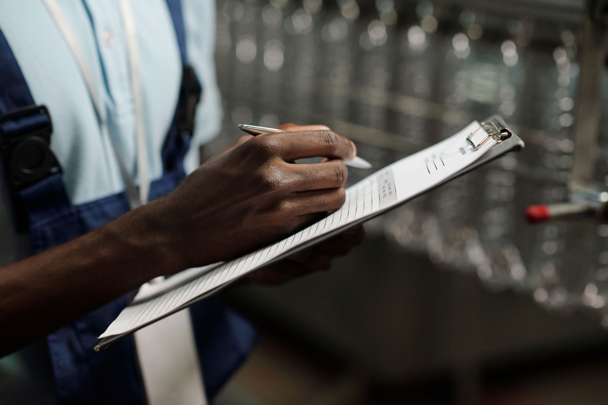 mechanic man writing on clipboard